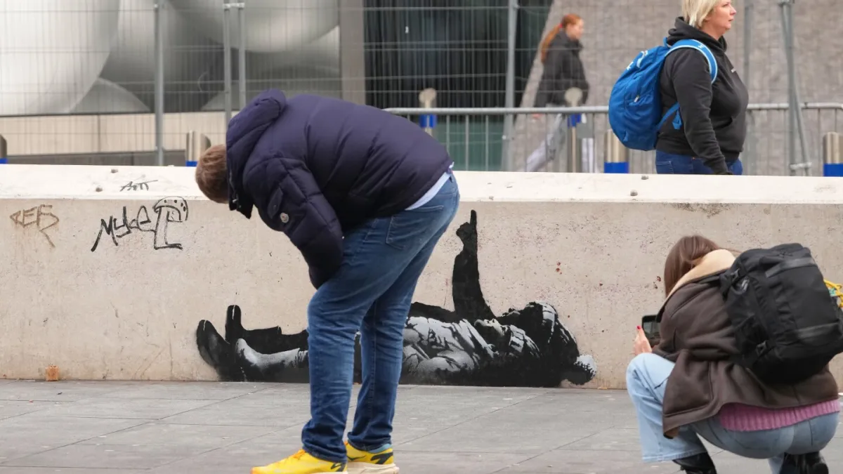 Banksy unveils new art in London following speculation over murals depicting stargazing figures