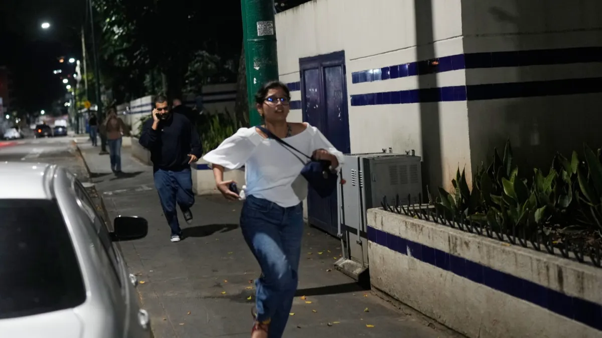 Behind the photo: How a woman running from US bombs in Venezuela captured the night’s fear and chaos